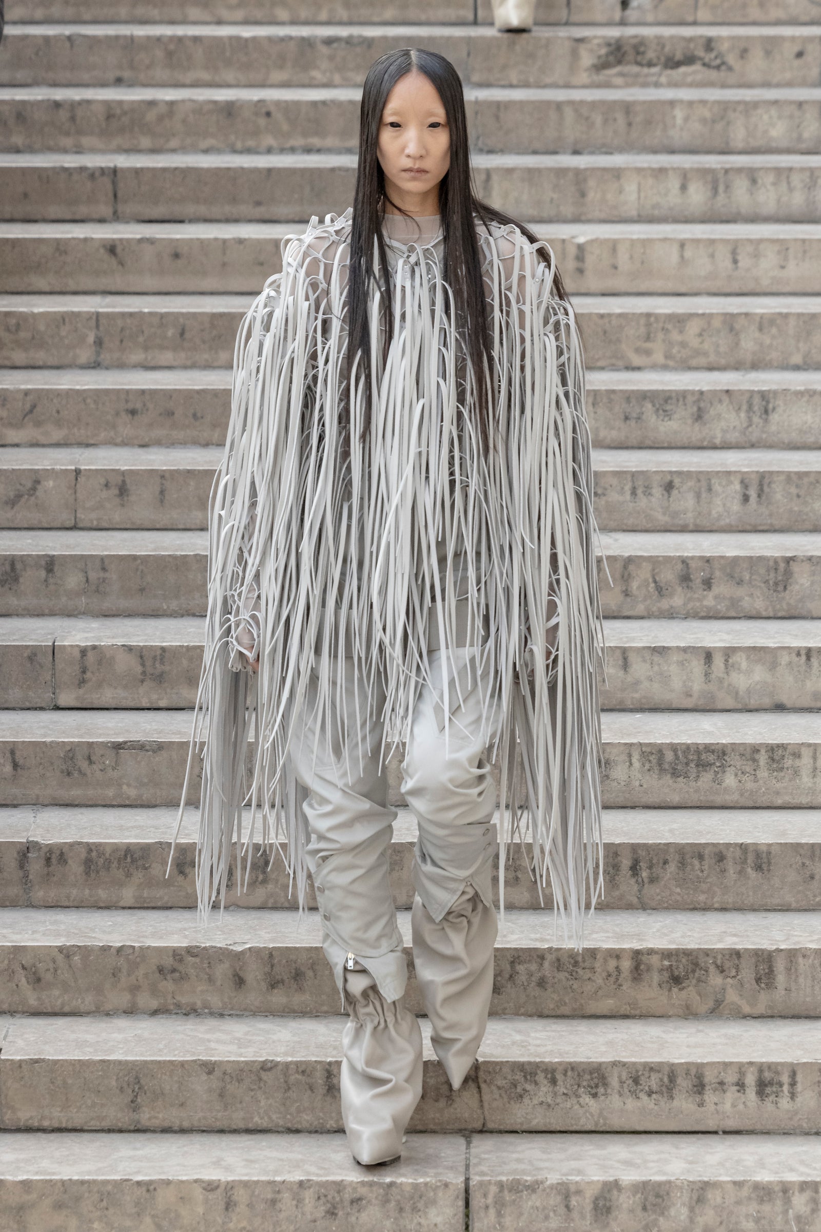 Rick Owens runway look featuring avant garde layered outfit with sculptural silhouette and dark tonal styling