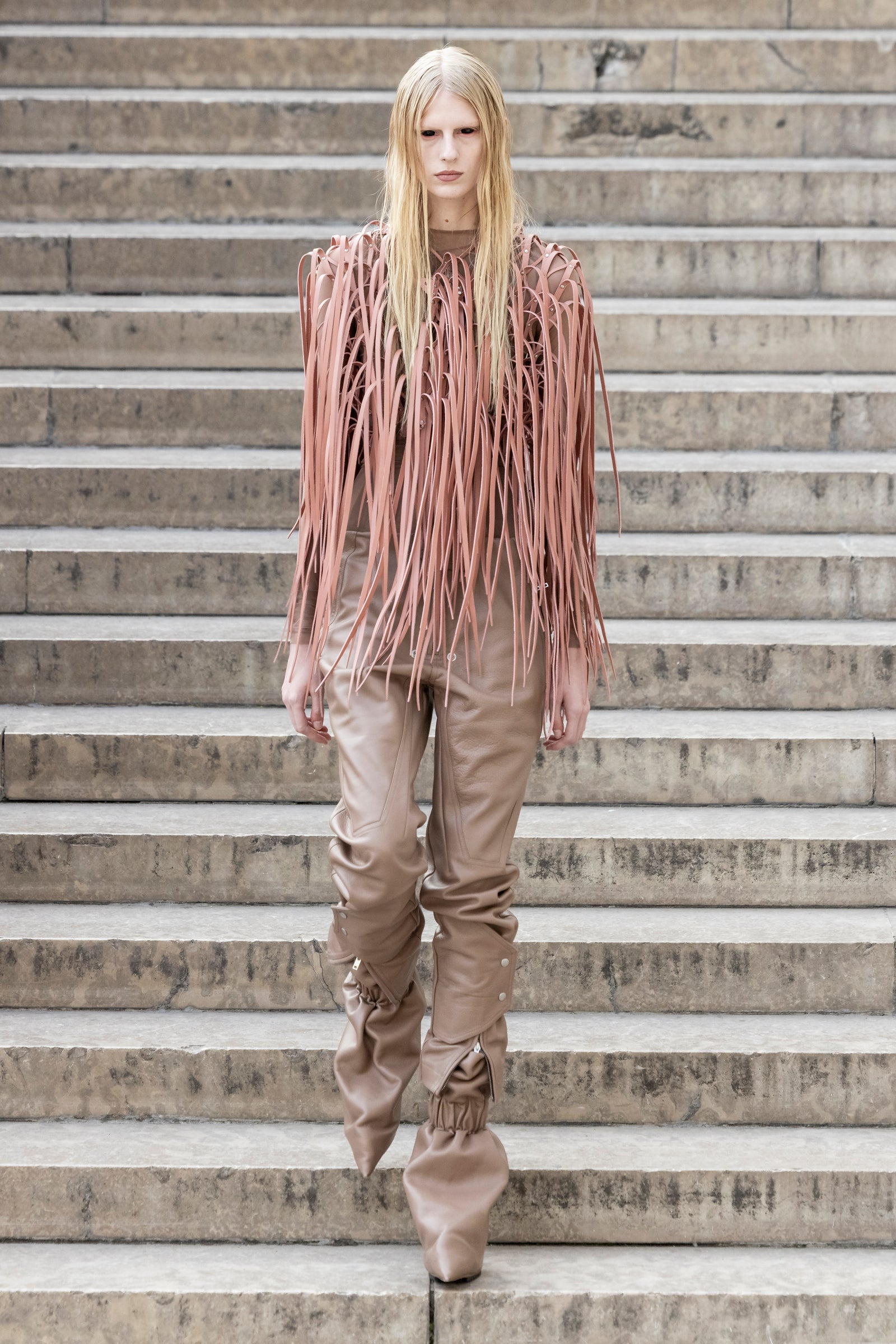 Rick Owens runway look featuring avant garde layered outfit with sculptural silhouette and dark tonal styling