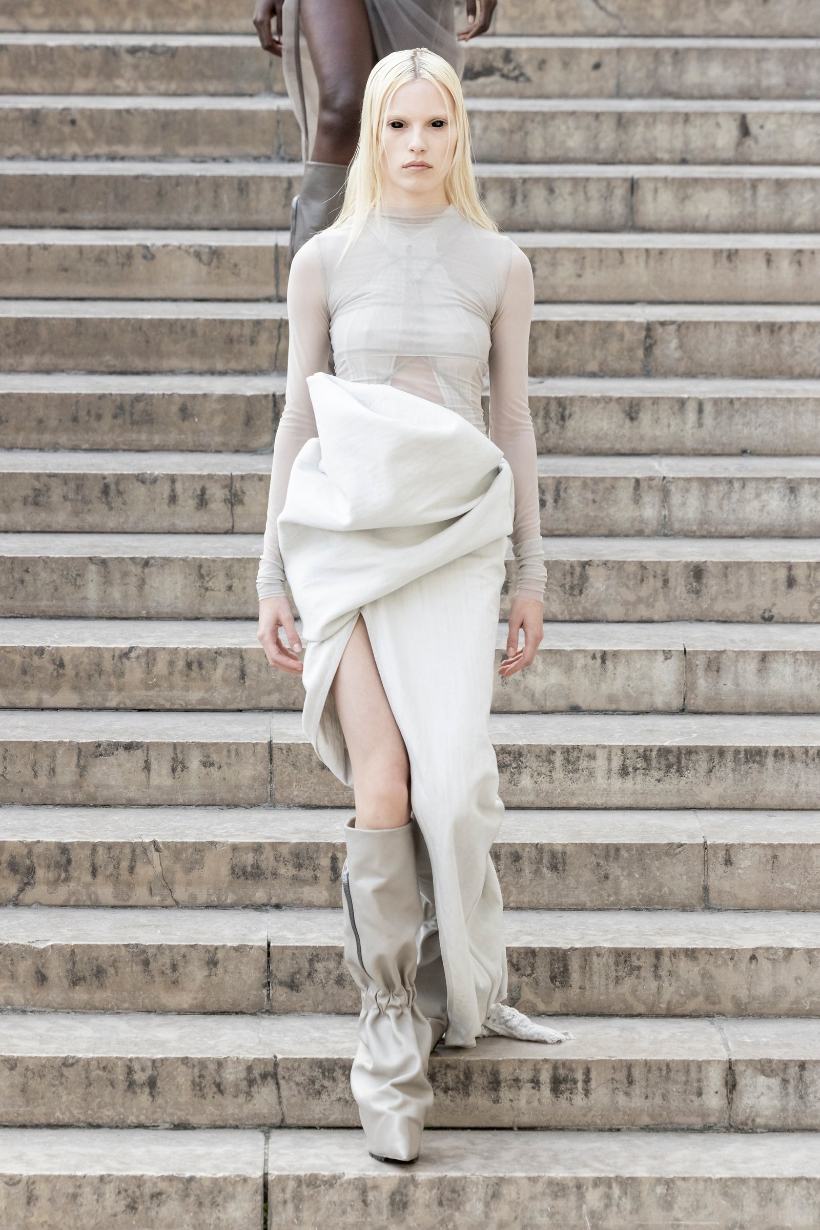 Rick Owens runway look featuring avant garde layered outfit with sculptural silhouette and dark tonal styling
