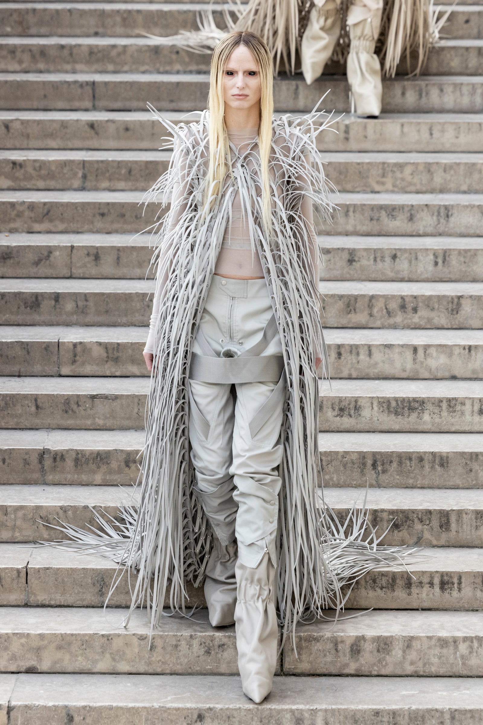 Rick Owens runway look featuring avant garde layered outfit with sculptural silhouette and dark tonal styling
