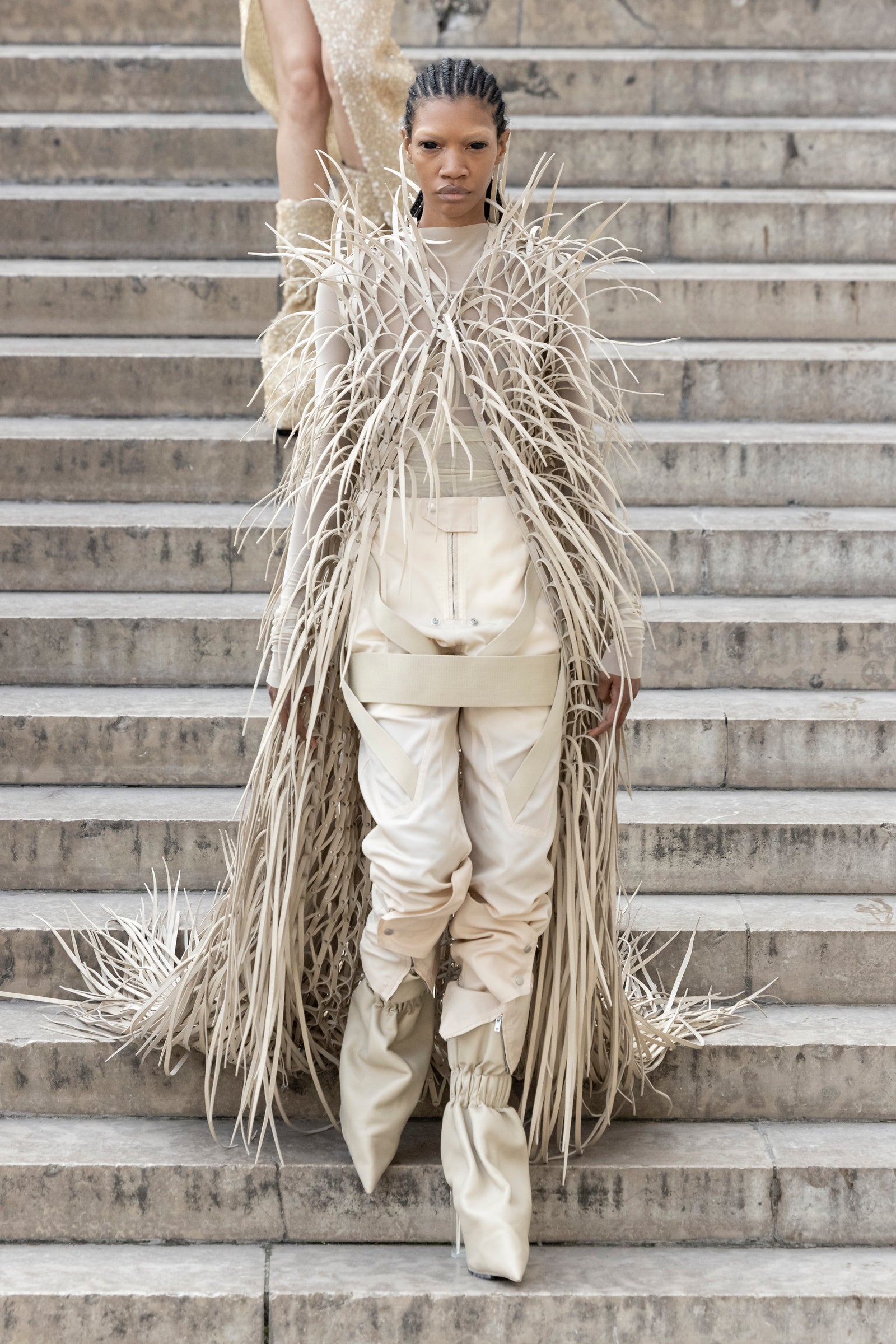 Rick Owens runway look featuring avant garde layered outfit with sculptural silhouette and dark tonal styling
