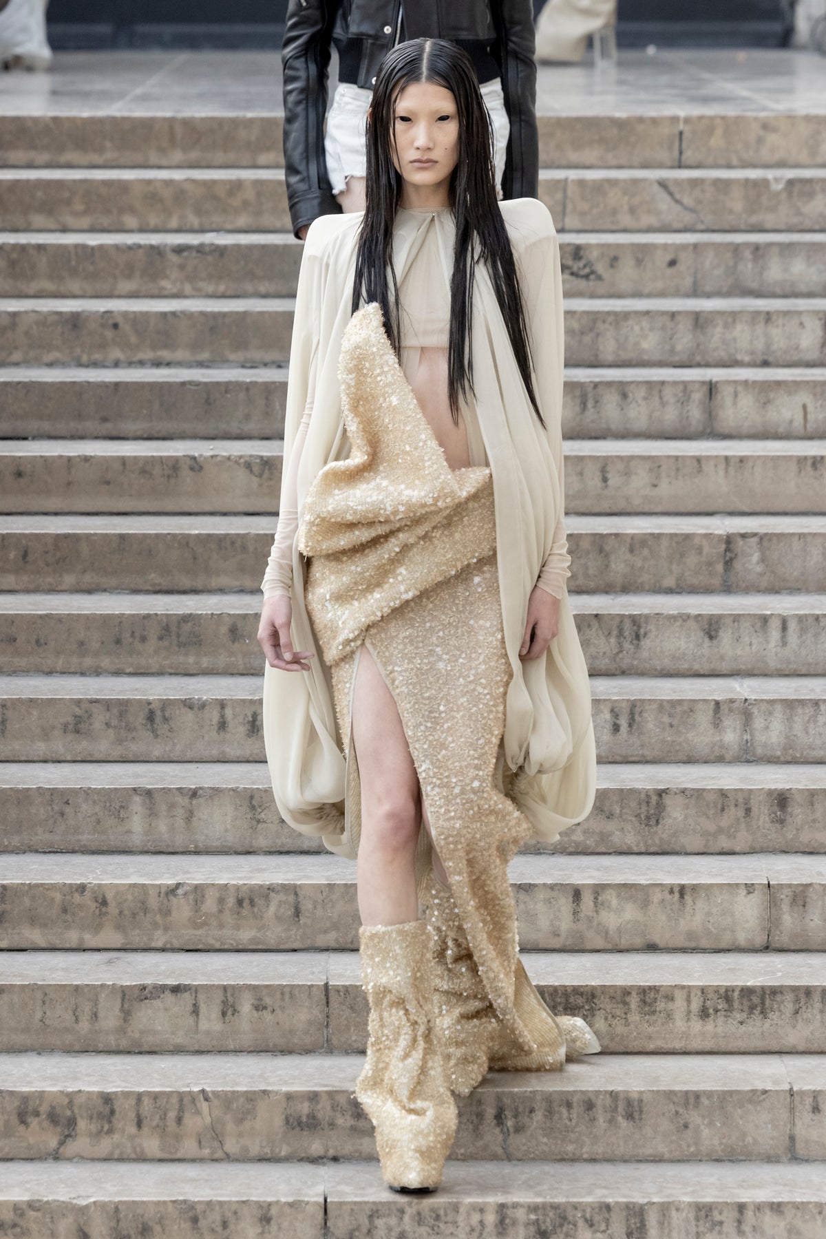 Rick Owens runway look featuring avant garde layered outfit with sculptural silhouette and dark tonal styling