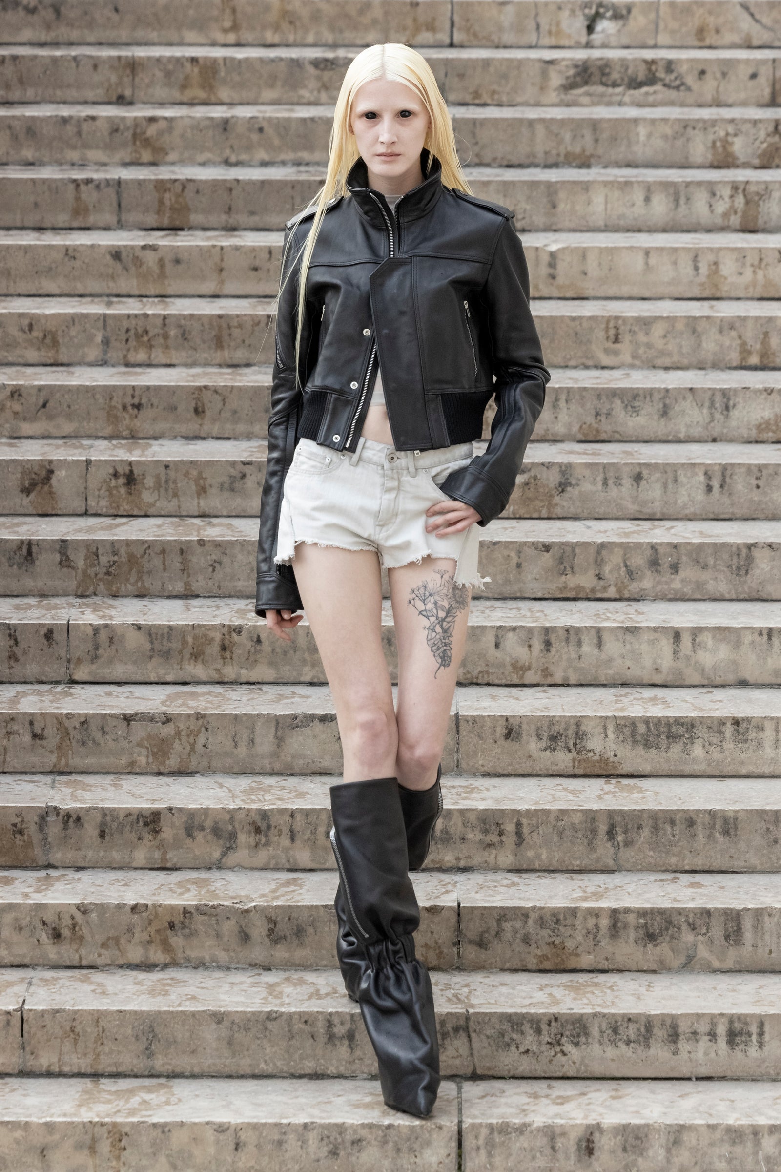 Rick Owens runway look featuring avant garde layered outfit with sculptural silhouette and dark tonal styling