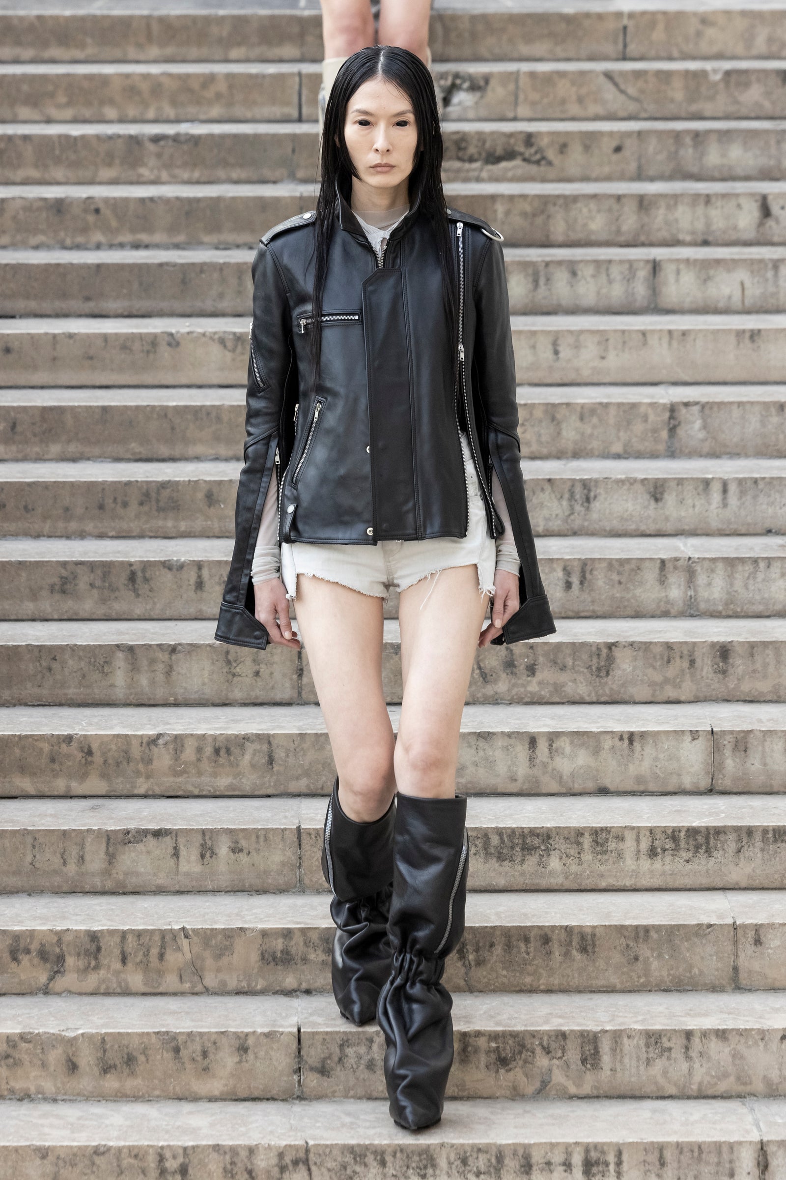 Rick Owens runway look featuring avant garde layered outfit with sculptural silhouette and dark tonal styling