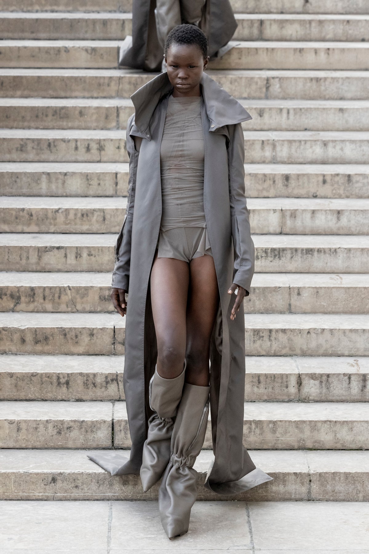 Rick Owens runway look featuring avant garde layered outfit with sculptural silhouette and dark tonal styling
