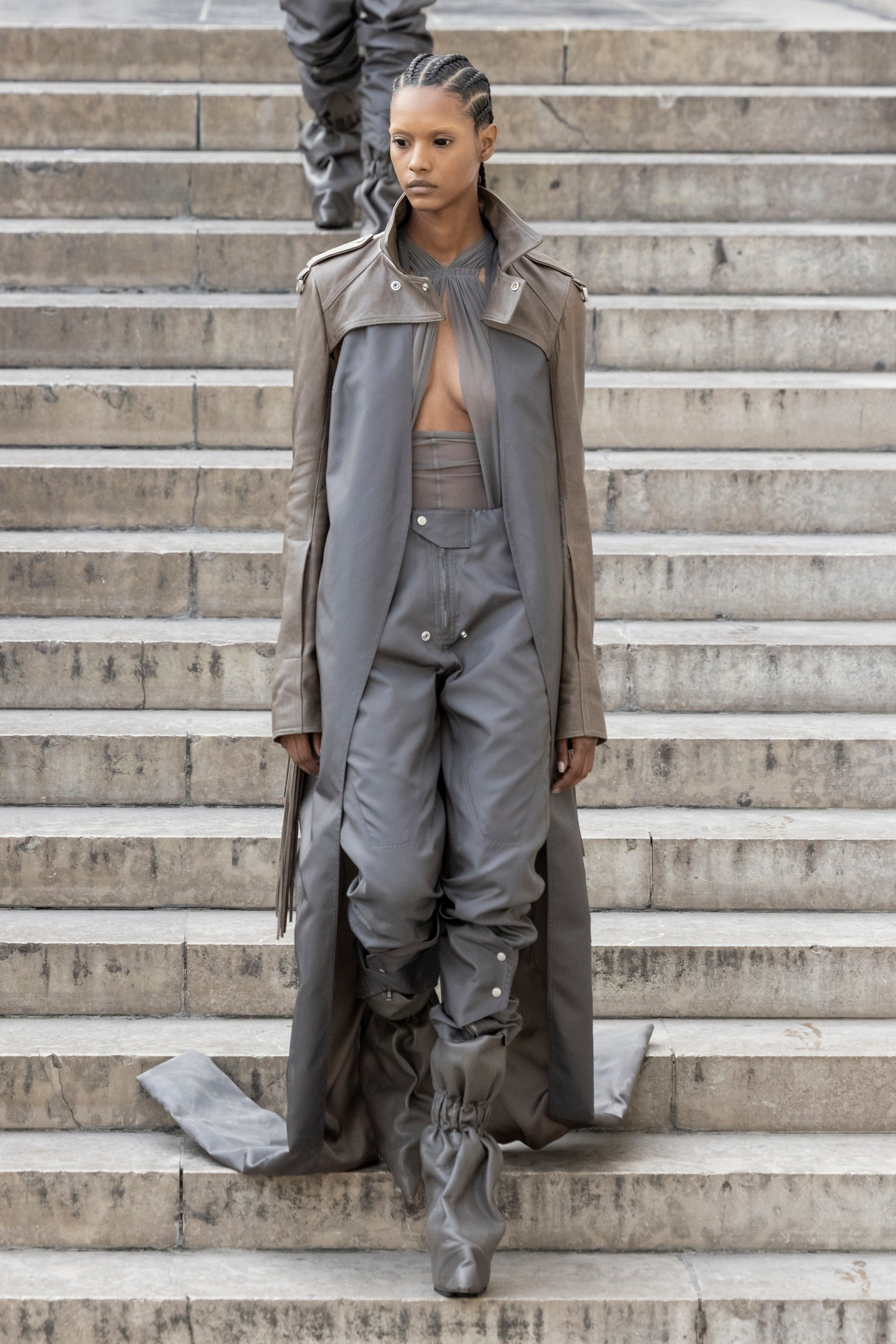 Rick Owens runway look featuring avant garde layered outfit with sculptural silhouette and dark tonal styling